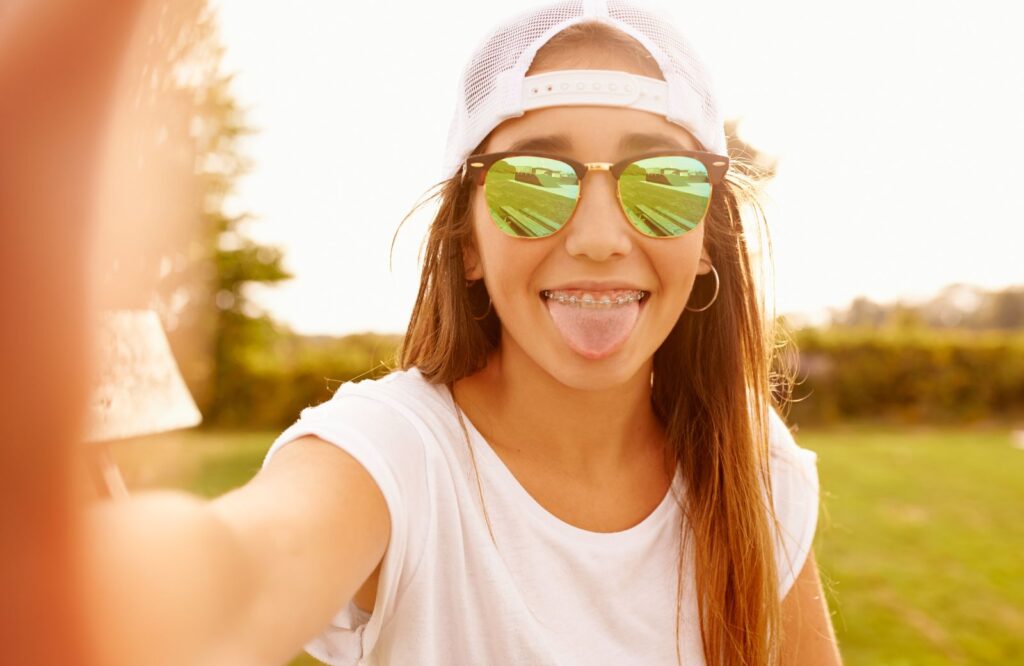 teen sticks out her tongue after using a tongue scraper