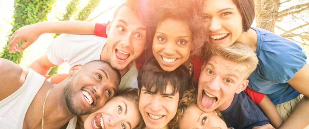 teens pose for a group selfie after learning what causes crowded teeth