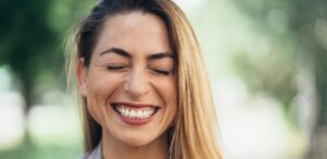 woman smiles learning how to clean retainers